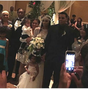 Mr. and Mrs. Kevin Gates with their families, including their toddler daughter Islah Gates (front center) and infant son Khaza Gates (being held by relative on the left).