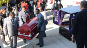 Tyshawn's body being carried inside red casket.