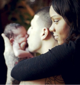 Shayanna Jenkins watches as her fiancé Aaron Hernandez kisses their daughter, Avielle Janelle Hernandez. 