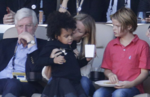 Gwyneth Paltrow holds Blue Ivy while Beyonce takes the stage.