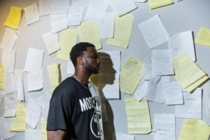 Gucci Mane in his home studio, in front of a wall covered in lyrics, many of which he wrote in prison. Credit Damon Winter/The New York Times